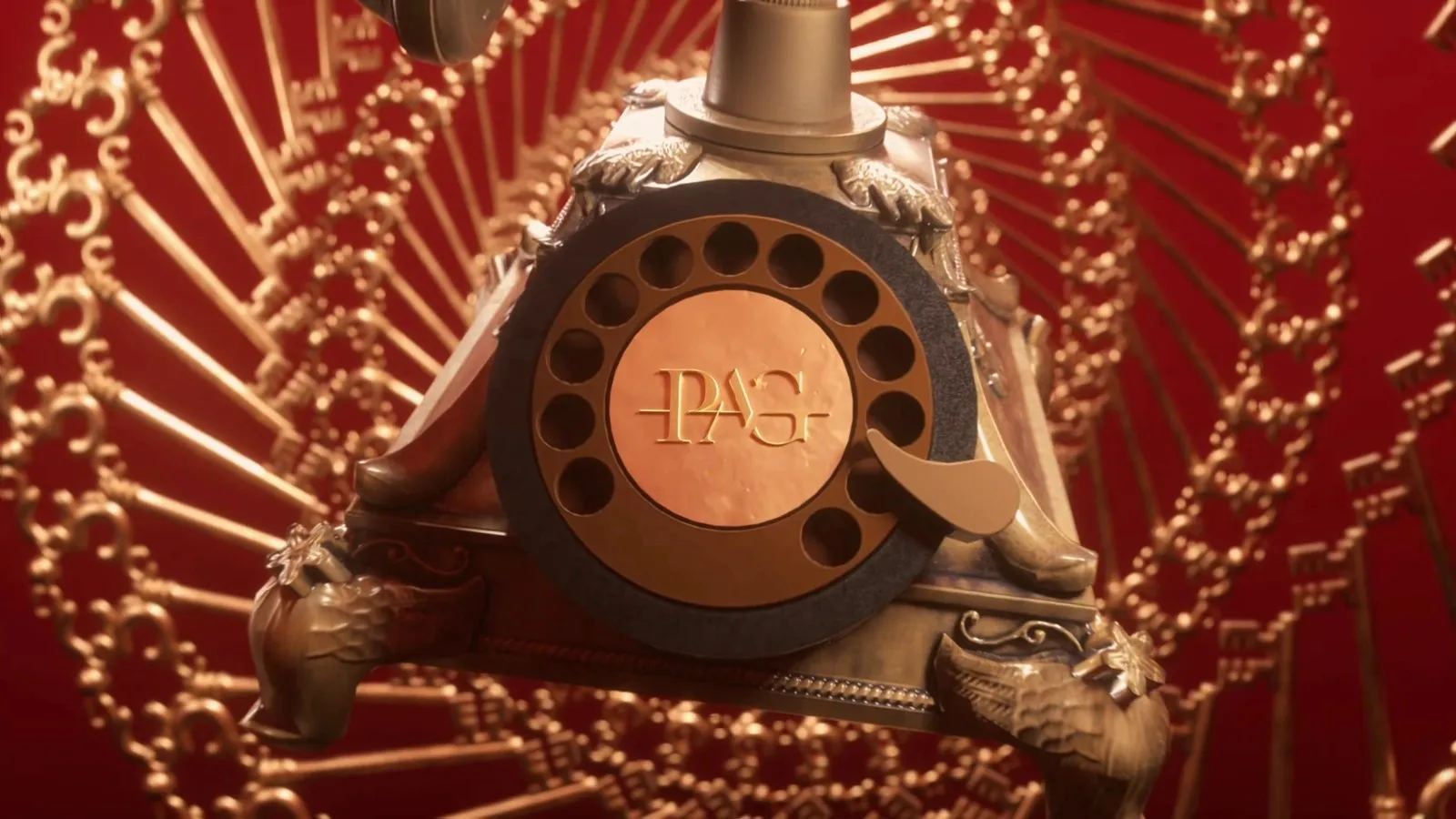 A rotary telephone with the PAG monogram on the dial, brass keys spiralling out behind it
